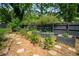 A charming garden showcases dark wood planters and stepping stone pathways, perfect for green thumbs and outdoor enjoyment at 1545 Montreat Sw Pl, Atlanta, GA 30311