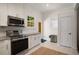 Clean kitchen features stainless steel appliances, neutral countertops, and ample cabinet space at 1545 Montreat Sw Pl, Atlanta, GA 30311