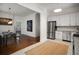 Open concept kitchen features stainless steel appliances, white cabinets and stone counter tops at 1545 Montreat Sw Pl, Atlanta, GA 30311