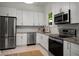 Bright kitchen features stainless steel appliances, and ample white cabinetry at 1545 Montreat Sw Pl, Atlanta, GA 30311
