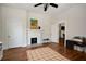 Inviting living room featuring hardwood floors, a fireplace, and a painting adding color to the space at 1545 Montreat Sw Pl, Atlanta, GA 30311