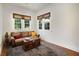 Sun-filled living room with many windows and a leather couch, providing a cozy and inviting atmosphere at 1545 Montreat Sw Pl, Atlanta, GA 30311