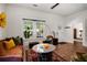 Sunlit living room with hardwood floors, a vintage rug, and an open layout for easy flow and entertaining at 1545 Montreat Sw Pl, Atlanta, GA 30311