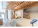 Cozy bedroom featuring wood ceiling and beams with a lounge chair near the bedroom window at 170 Boulevard Se # 521H, Atlanta, GA 30312