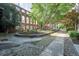 Picturesque courtyard featuring trees, pathways, seating, and a historic brick facade at 170 Boulevard Se # 521H, Atlanta, GA 30312
