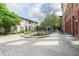 Scenic courtyard view highlighting the charming stone patio, mature trees, and brick building backdrop for outdoor enjoyment at 170 Boulevard Se # 521H, Atlanta, GA 30312
