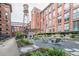 Courtyard featuring an outdoor fireplace, modern seating, and lush landscaping at 170 Boulevard Se # 521H, Atlanta, GA 30312