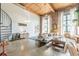 Bright living room with a spiral staircase, exposed brick, high ceilings, and modern furnishings at 170 Boulevard Se # 521H, Atlanta, GA 30312