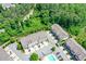 Overhead view of townhomes with brick and siding nestled in a lush, green community at 2187 Elmont Se Way, Smyrna, GA 30080
