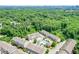 Beautiful aerial shot of community townhomes, pool, and surrounded by lush trees with city skyline in the distance at 2187 Elmont Se Way, Smyrna, GA 30080