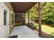 A covered back patio offers shade and a view of the fenced backyard with green foliage at 2187 Elmont Se Way, Smyrna, GA 30080
