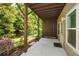 A covered back patio offers shade and a view of the fenced backyard with green foliage at 2187 Elmont Se Way, Smyrna, GA 30080