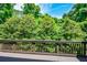 View of a lush, green backyard from a wooden deck, showcasing a serene and private outdoor space at 2187 Elmont Se Way, Smyrna, GA 30080