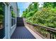 Wooden deck offering views of the surrounding lush trees and greenery, showcasing a private outdoor space at 2187 Elmont Se Way, Smyrna, GA 30080