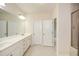 Bathroom features a double vanity, large mirror, and tiled shower with glass doors at 2187 Elmont Se Way, Smyrna, GA 30080