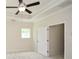 Bright bedroom featuring tray ceilings, ceiling fan, and ample natural light at 2187 Elmont Se Way, Smyrna, GA 30080