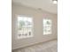 Upstairs bedroom with two double-hung windows showcasing a neighborhood view at 2187 Elmont Se Way, Smyrna, GA 30080