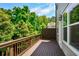 A cozy wood deck has outdoor access and offers a private space surrounded by trees and natural light at 2187 Elmont Se Way, Smyrna, GA 30080