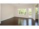 Open dining room with a modern chandelier, gleaming hardwood floors, and a door leading to a backyard deck at 2187 Elmont Se Way, Smyrna, GA 30080