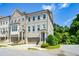 Beautiful townhome with a gray painted brick facade, two-car garage and charming architectural details at 2187 Elmont Se Way, Smyrna, GA 30080