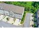 Aerial view of a beautiful three-story townhome with brick and siding and a two-car garage at 2187 Elmont Se Way, Smyrna, GA 30080