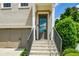 Close-up of the front door entrance of the home, featuring stone steps and a modern steel handrail at 2187 Elmont Se Way, Smyrna, GA 30080