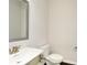 Well-lit half bathroom with a modern vanity, silver mirror, and a toilet at 2187 Elmont Se Way, Smyrna, GA 30080