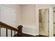 Hallway with a built-in bench, hooks, and view to an adjacent bathroom; wood-style floor at 2187 Elmont Se Way, Smyrna, GA 30080