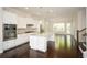Bright, open kitchen with white cabinetry, large island, and stainless steel appliances at 2187 Elmont Se Way, Smyrna, GA 30080