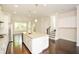 Bright, open kitchen with white cabinetry, large island, and stainless steel appliances at 2187 Elmont Se Way, Smyrna, GA 30080