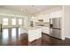 Bright, open kitchen with white cabinetry, large island, and stainless steel appliances at 2187 Elmont Se Way, Smyrna, GA 30080