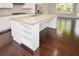 Spacious kitchen island with stone countertop, storage shelves, and hardwood flooring at 2187 Elmont Se Way, Smyrna, GA 30080