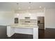 Open concept kitchen featuring a large island with granite countertops and stainless steel appliances at 2187 Elmont Se Way, Smyrna, GA 30080
