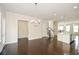 Open living room with hardwood floors, modern lighting, and views into the kitchen and dining areas at 2187 Elmont Se Way, Smyrna, GA 30080