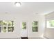 Bright living room with three windows providing natural light and a door leading to outdoor space at 2187 Elmont Se Way, Smyrna, GA 30080