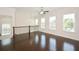 Bright loft area featuring three windows and dark, glossy wood floors at 2187 Elmont Se Way, Smyrna, GA 30080
