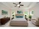 Stylish main bedroom with tray ceilings, a ceiling fan, and modern decor at 2187 Elmont Se Way, Smyrna, GA 30080