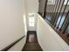 Interior staircase with dark wood treads, white risers, and black metal handrail, leading up to the next floor at 2187 Elmont Se Way, Smyrna, GA 30080