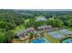 Overhead view of townhomes with tennis courts and a picturesque lake showcasing the scenic landscape at 232 Heron Pointe Vw, Canton, GA 30114