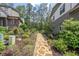 Tranquil backyard stone pathway amidst lush greenery and manicured garden beds at 232 Heron Pointe Vw, Canton, GA 30114