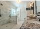 Elegant bathroom boasts a glass enclosed shower with seat and granite countertop vanity at 232 Heron Pointe Vw, Canton, GA 30114
