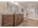 Modern bathroom with wood cabinets, stone countertops, and a glass walk-in shower at 232 Heron Pointe Vw, Canton, GA 30114