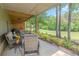 Enjoy outdoor living on this home's covered patio overlooking a meticulously manicured lawn with lush trees at 232 Heron Pointe Vw, Canton, GA 30114