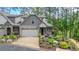 Charming townhome with a two-car garage and beautifully landscaped front yard at 232 Heron Pointe Vw, Canton, GA 30114