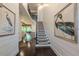Elegant foyer featuring a staircase, hardwood floors, and stylish wall art at 232 Heron Pointe Vw, Canton, GA 30114