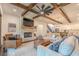 Open living room with fireplace, beamed ceilings, and hardwood floors adjacent to kitchen and dining area at 232 Heron Pointe Vw, Canton, GA 30114