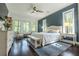Calm primary bedroom featuring large windows, a ceiling fan, and stylish decor at 232 Heron Pointe Vw, Canton, GA 30114