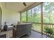Relaxing screened porch with comfortable seating and a view of the landscaped backyard at 232 Heron Pointe Vw, Canton, GA 30114