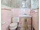 Pink tiled bathroom showing a toilet and vanity, needing complete renovation at 2322 Paces Ferry Se Rd, Smyrna, GA 30080