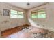Bedroom in disrepair with damaged walls and hardwood floors at 2322 Paces Ferry Se Rd, Smyrna, GA 30080